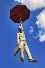 Man jumping with umbrella, art object in Prague, Czech Republic, Europe