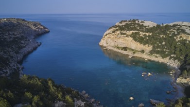 Drone shot, A picturesque, calm bay with crystal clear water and steep cliffs, surrounded by