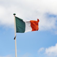 Irish national flag, tricolour waving against a slightly cloudy sky, Dublin, Ireland, Europe