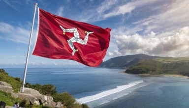 The flag of the Isle of Man, Great Britain, flutters in the wind