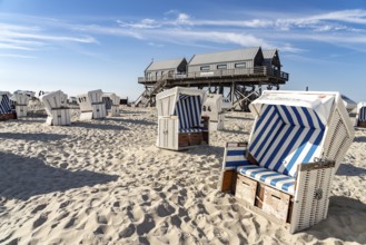 Beach chairs and pile dwellings on the beach at Sankt Peter-Ording, Nordfriesland district,