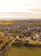 Bird's eye view of a small town with autumnal colours in a wide landscape, Jettingen, Black Forest,