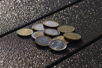 Euro, coins, small change, glow, Various cent and euro coins lie on a table in front of a blurred,