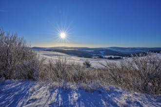 Bright sun over white hills with clear sky, winter, Wasserkuppe, Gersfeld, Rhön, Hesse, Germany,