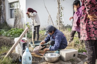 Lu Jua Ling prepares a duck for her colleagues to eat, Duck Breeding Centre Jiang Su Xiang Gui