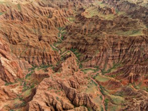 Eroded mountain landscape, top-down, canyon with red and orange rock formations, aerial view,