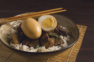 Stewed eggs, with pork belly, and rice, chinese food, homemade, selective focus, rustic, no people