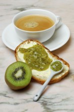 Kiwi, slice of bread with kiwi jam, cup of coffee (Actinidia chinensis, Actinidia (Actinidia