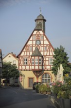 Historic town hall as half-timbered house with spire and bay window in Bergen, Main, Frankfurt,