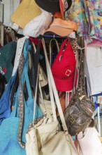 Handbags and caps for sale inside second hand goods and chattels store, Quebec, Canada, North