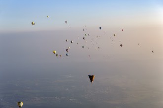 Many different hot air balloons on the way in the blue sky, distance, hot air balloon festival,