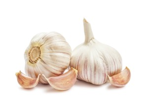 Two garlic bulbs and cloves isolated on white background