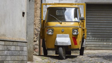 Bronze Ape, tricycle transporter, grey alley, Randazzo, town, Nebrodi National Park, Sicily, Italy,