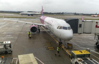 Wizz Air Airbus A320 plane at south terminal, London Gatwick airport, England, UK viewed through