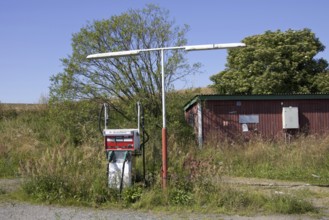 Old petrol pump at abandoned and overgrown gas station, Skåne, Sweden, Europe