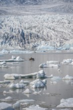 Boats with tourists in the glacier lagoon, ice lagoon Fjallsárlón, ice floes in front of glacier