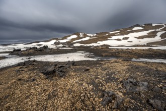 Snow-covered volcanic landscape with tuff and petrified lava, crater of Askja volcano, Icelandic