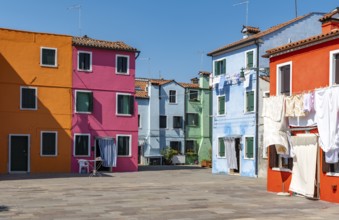 Colourful houses with washing lines, colourful house facades, alleyways on the island of Burano,