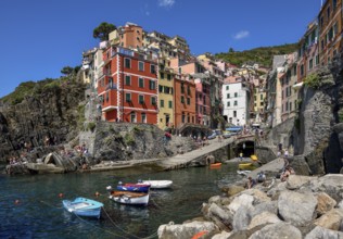 Fishing boats in the harbour of Riomaggiore, village view, Cinque Terre, province of La Spezia,