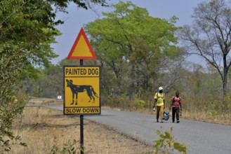 Warning Sign Painted dog, Attention African Wild Dogs, Hwange National Park, near Hwange,