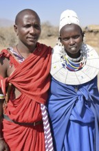 Maasai man and a woman wearing traditional dress, Ngorongoro Conservation Area, Ndema, Tanzania,