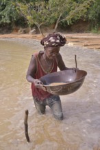 Female gold panner near Koidu, Kono District, Eastern Province Region, Sierra Leone, Africa