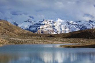 Himalayas mountains refelcting in mountain lake Dhankar Lake. Spiti Valley, Himachal Pradesh,