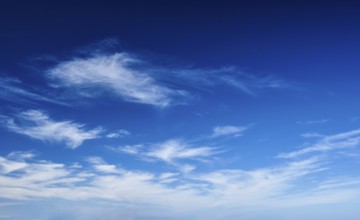 Blue clear sky with white cirrus spindrift clouds background