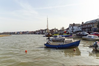 Boats and houses on waterside of River Colne, Rowhedge, Essex, England, UK