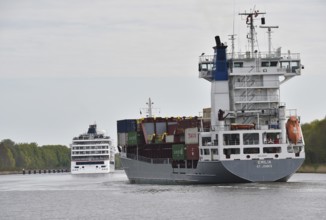 Cruise ship Hanseatic Inspiration and container ship on voyage through the Kiel Canal,