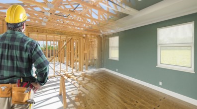 Contractor facing before and after interior of house wood construction framing and finished build