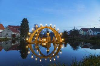 Floating candle arch in the village pond of Bärnsdorf near Moritzburg. The arch is 4.5m high,