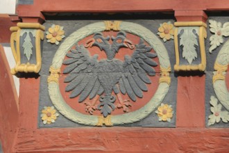 Wood carving with double eagle and floral ornaments at the historical Amthof, detail, ornaments,