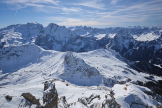 View of a ski resort piste and Dolomites mountains in Italy from Passo Pordoi pass. Arabba, Italy,