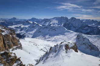 View of a ski resort piste and Dolomites mountains in Italy from Passo Pordoi pass. Arabba, Italy,