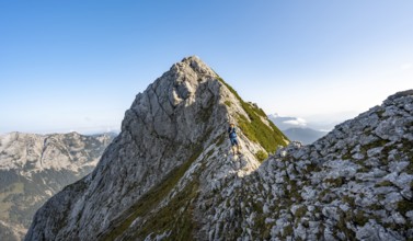 Mountaineer on a narrow ridge, mountain tour to the summit of the Hochkalter, Hochkalter crossing,