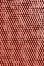 Façade cladding made of red textured panel