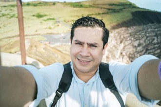 Close up of man taking an adventure selfie, Tourist taking a selfie at a viewpoint. Adventurous