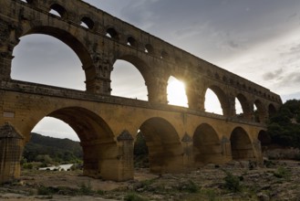 Pont du Gard, Roman aqueduct over the River Gardon, Sunbeams, Languedoc-Roussillon, South of