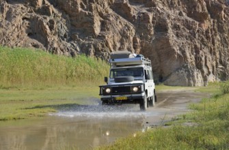 Safari vehicle in the Hoarusib river valley, Purros, Kaokoland, Kunene, Namibia, Africa