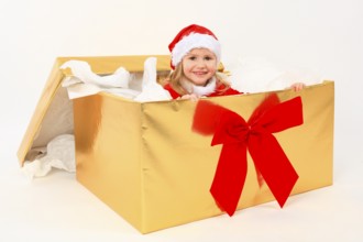 Girl looks out Christmas present, box, gift box