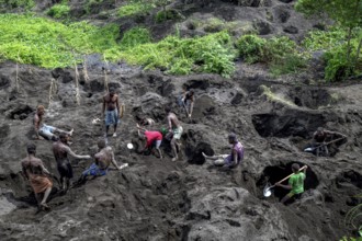 Egg collectors dig at the foot of the still active volcano Mount Tavurvur for eggs of Melanesian