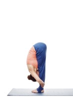 Woman doing Ashtanga Vinyasa Yoga Surya Namaskar Sun Salutation asana uttanasana, standing forward