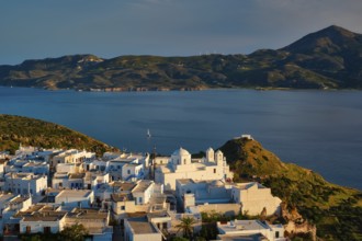 View of Plaka village on Milos island with traditional greek white houses with Greek Orthodox