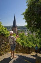 Elevated view from the Schlossberg to the church tower of St. Marien and the steep staircase into