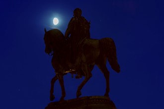 Equestrian statue of King John of Saxony in the evening theatre square in front of the moon