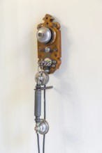 Ancient, antique telephone hanging on a room wall, historic, history, communication