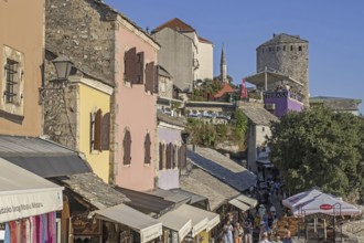 Tourists and souvenir shops in the 16th century Old Town of Mostar, built by the Ottomans,