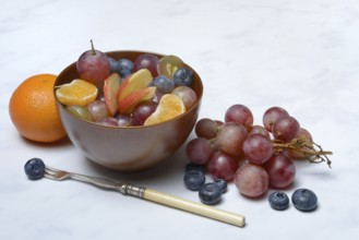 Various pieces of fruit in bowl, fruit salad