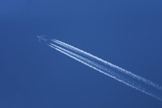 Commercial aircraft with condensation trails, blue sky, Bavaria, Germany, Europe